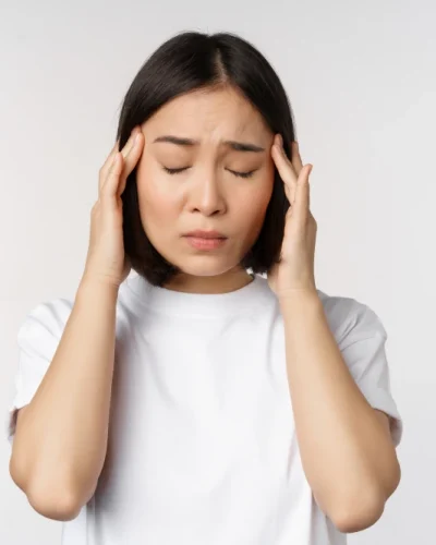 portrait-asian-girl-feeling-headache-migraine-being-ill-standing-white-tshirt-white-background